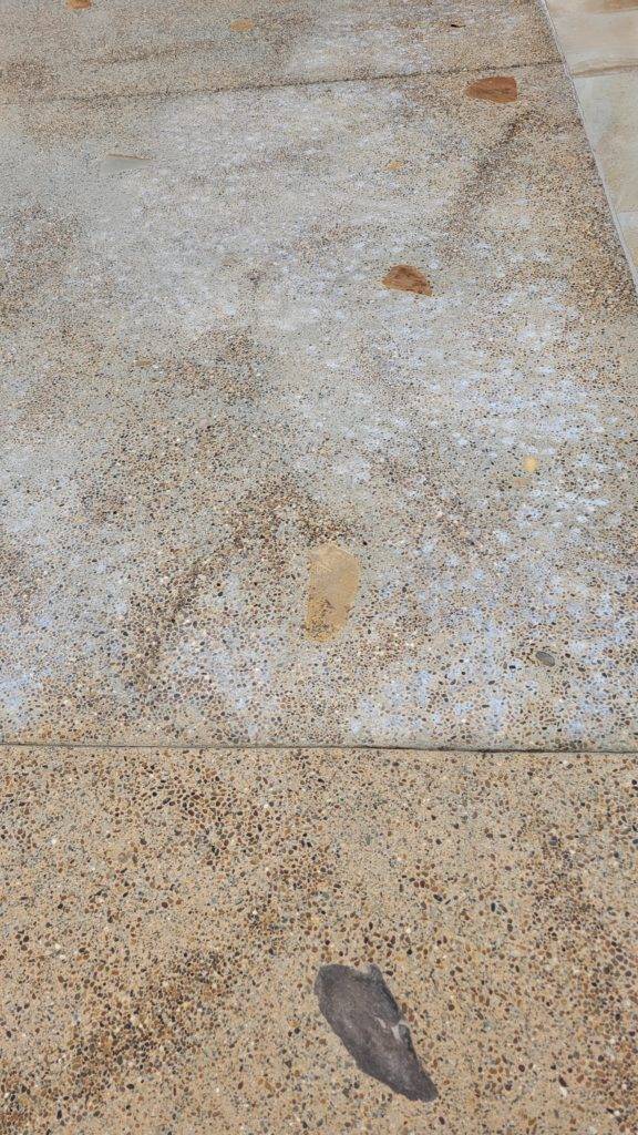White efflorescence deposits on concrete