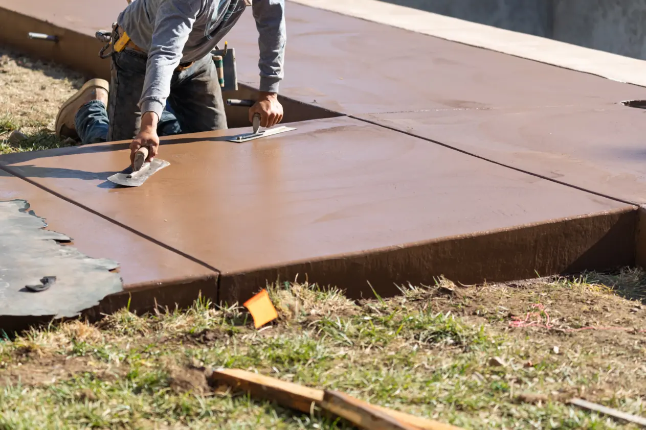 concrete-driveway-resurfacing-and-repairs- Colored concrete driveway being hand-finished in Chula Vista
